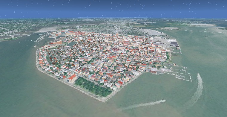 The Charleston peninsula from the air — a dense grid of extruded building footprints in reds, whites and greys, surrounded by harbour water on three sides.